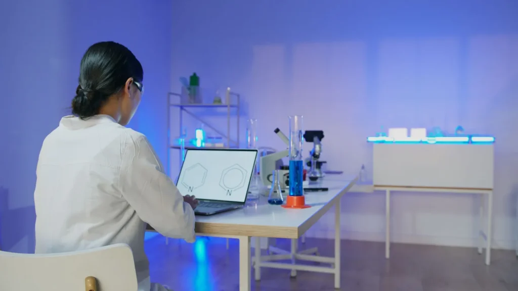 Científica analizando estructuras moleculares con ordenador como referencia a Iambic Therapeutics y la IA farmacéutica